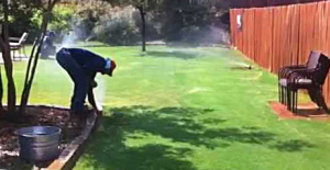 adjusting a Rainbird pop up head during a sprinkler repair in Hialeah, FL