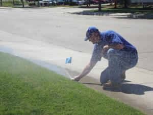 one of our West Little River sprinkler repair pros is checking the newly installed sprinkler head